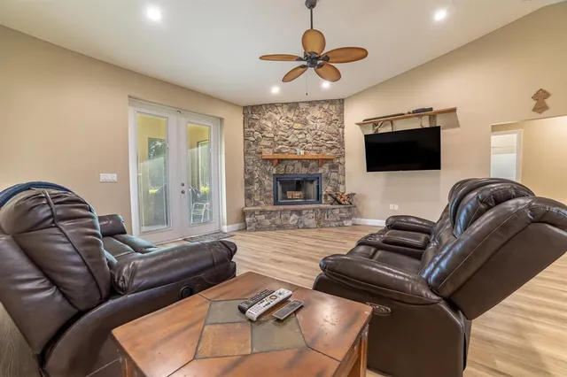 a living room with furniture a flat screen tv and a fireplace