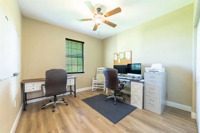 a view of a workspace with furniture and a window