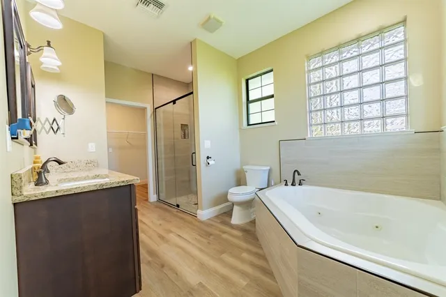 a view of a bathroom with a tub sink and mirror
