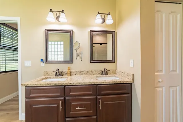 a bathroom with a double vanity sink and a mirror