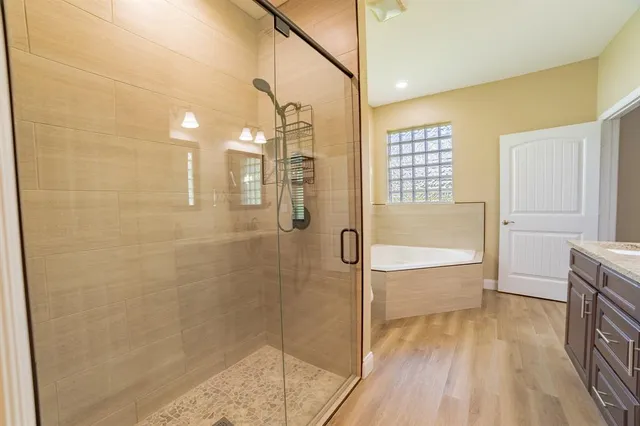 a bathroom with a bathtub and shower