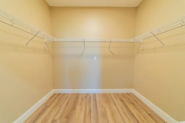 a view of a room with wooden floor