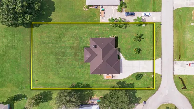 an aerial view of a house with a yard