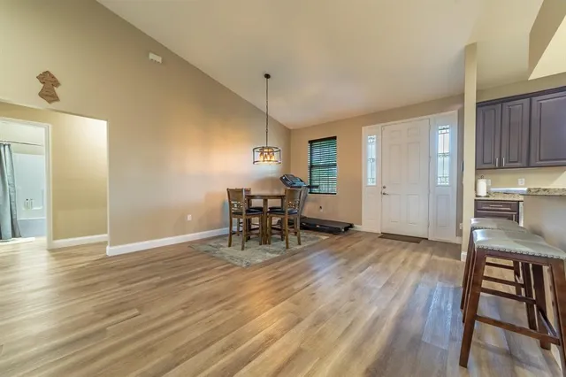 a view of a kitchen with a dining table chairs and entryway