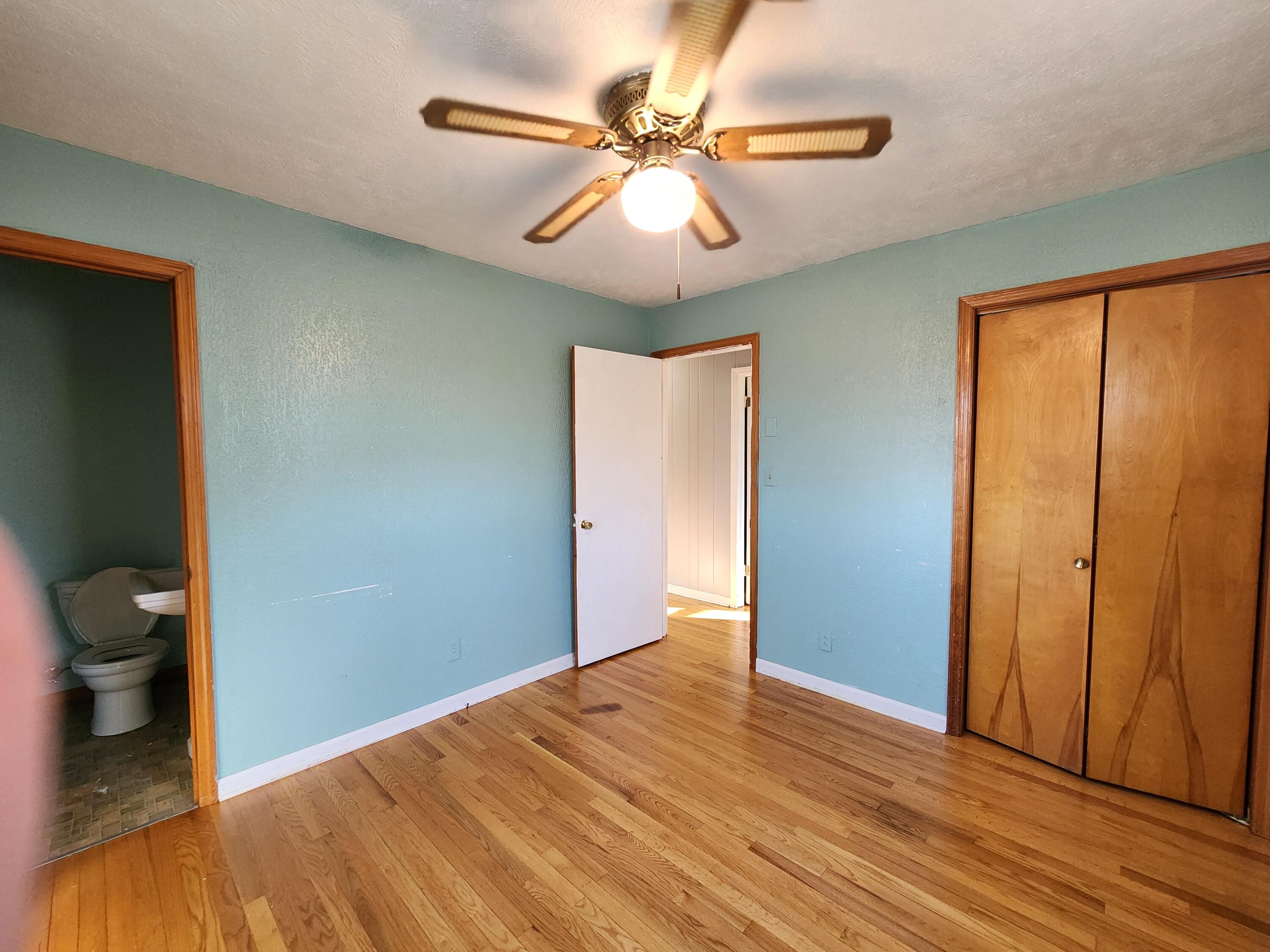 10519 Henry Road Henry, VA 24102 - Photo 17 of 25 a view of a room with wooden floor and a ceiling fan