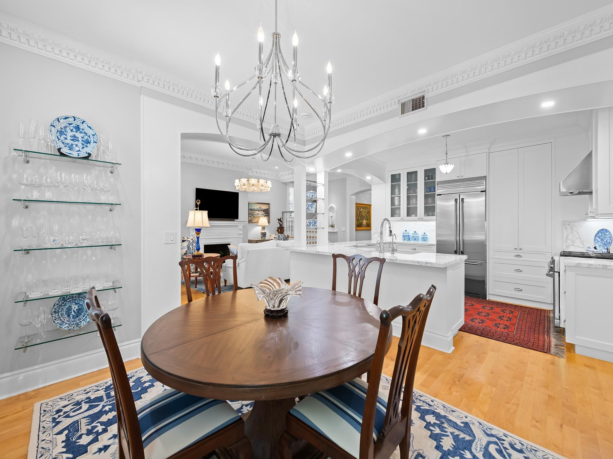 525 North Victoria Park Road Fort Lauderdale, FL 33301 - Photo 16 of 52 a dining room with wooden floor a chandelier a wooden table and chairs