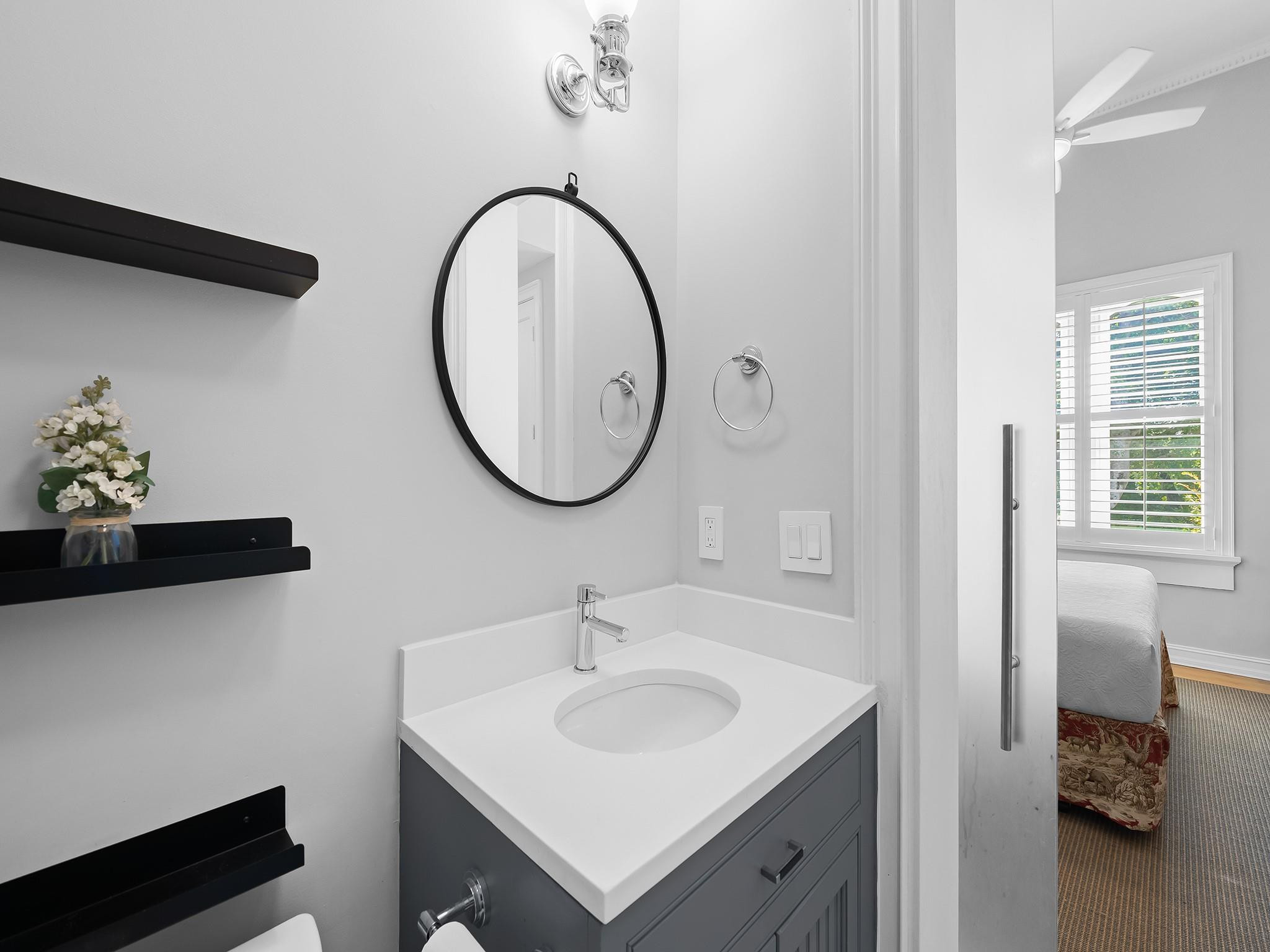 525 North Victoria Park Road Fort Lauderdale, FL 33301 - Photo 32 of 52 a bathroom with a sink and a mirror