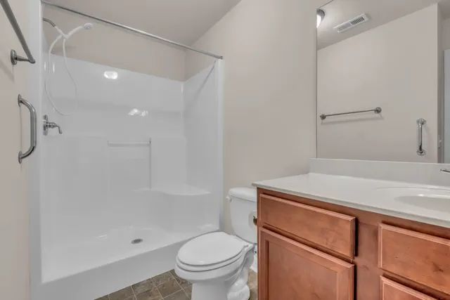 a view of house with a small yard and wooden fence