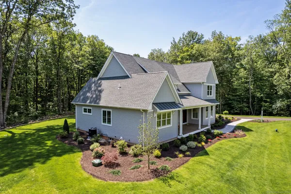 a aerial view of a house with swimming pool garden and patio