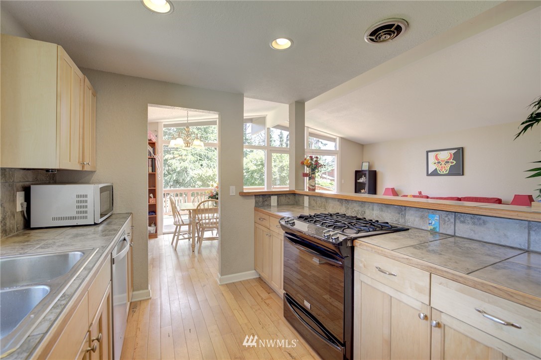 1 172nd Place Southwest Bothell, WA 98012 - Photo 11 of 27 a kitchen with stainless steel appliances granite countertop a stove and a sink