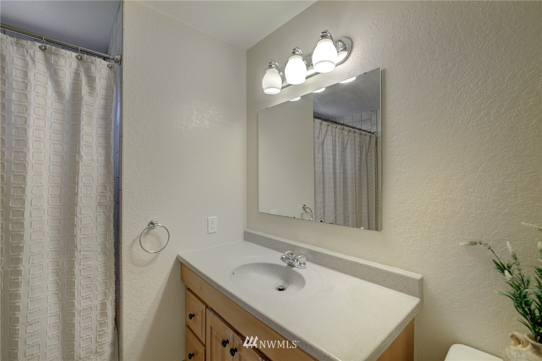 1 172nd Place Southwest Bothell, WA 98012 - Photo 14 of 27 a bathroom with a sink a mirror and a light fixture