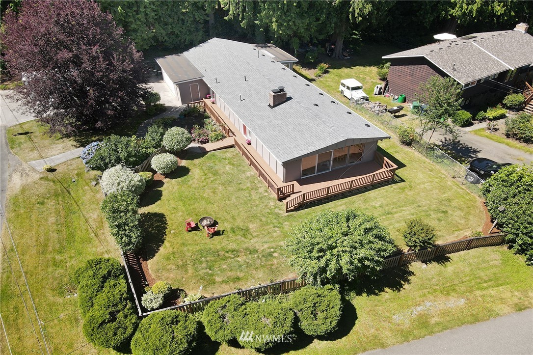 1 172nd Place Southwest Bothell, WA 98012 - Photo 23 of 27 a aerial view of a house with swimming pool and lawn chairs under an umbrella