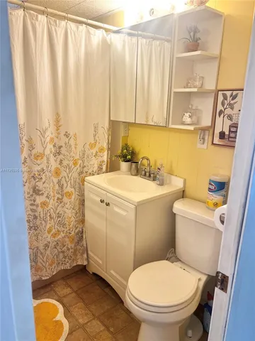 a view of a big room with lots of furniture and white walls