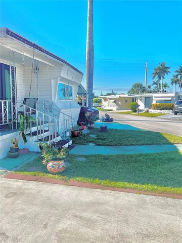a view of backyard with swimming pool and outdoor seating