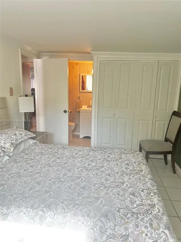 a bedroom with a bed and chair