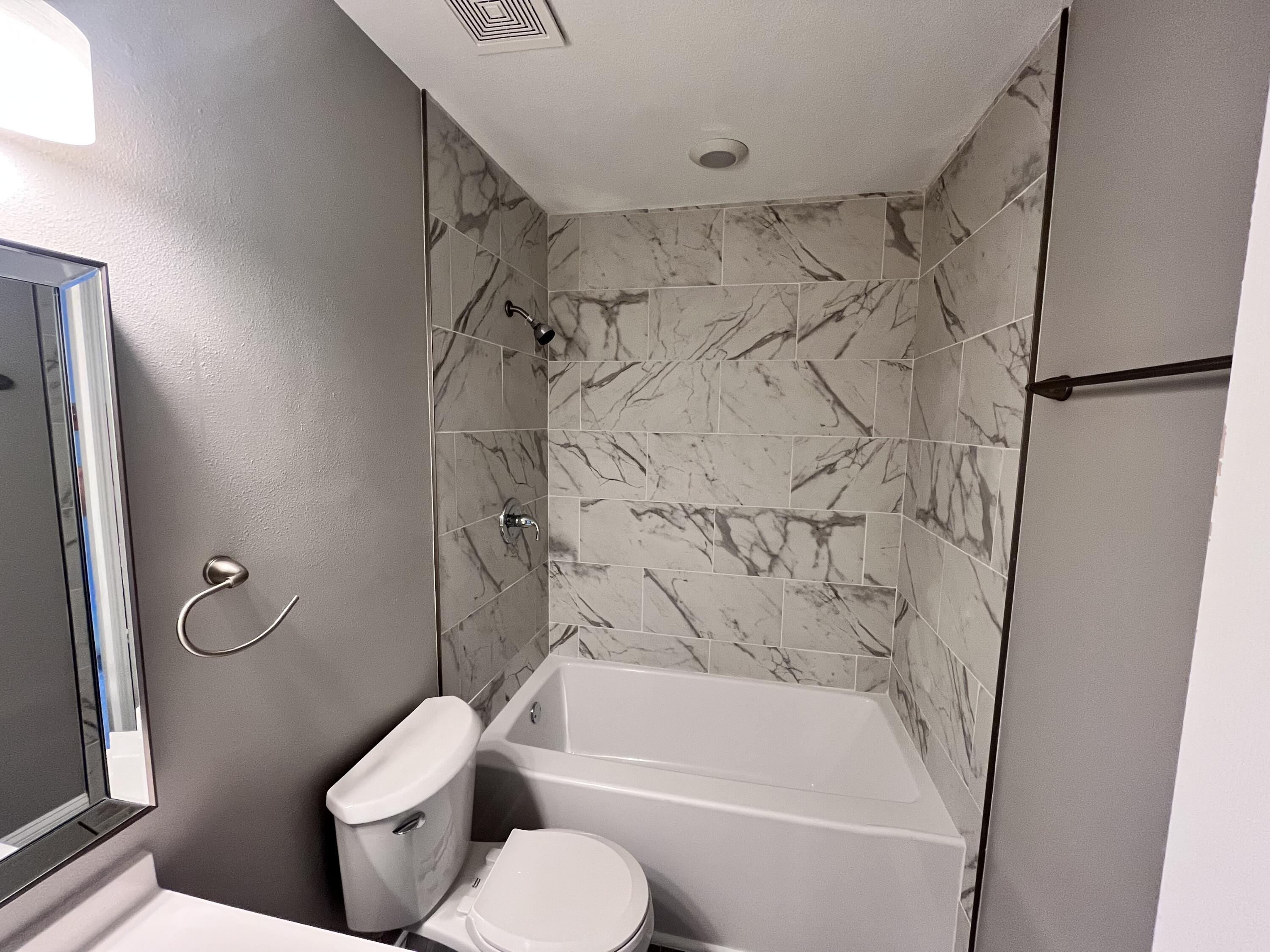 795 Bay Street Crestview, FL 32536 - Photo 13 of 16 a bathroom with a toilet and a bathtub