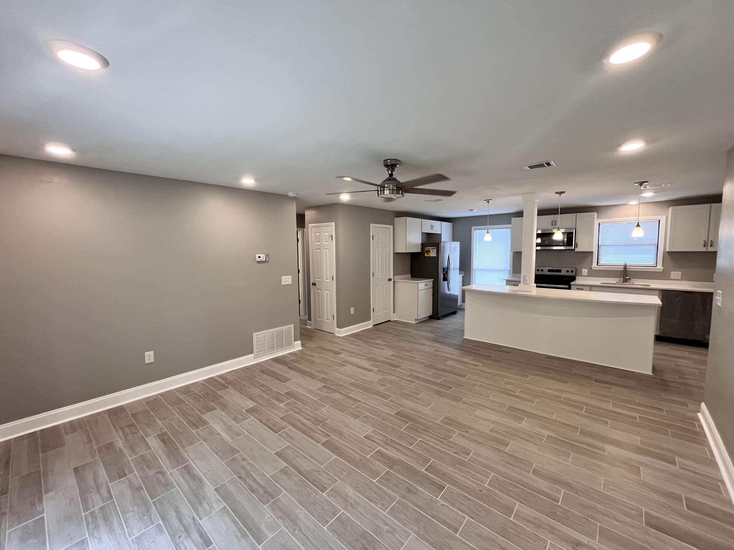 795 Bay Street Crestview, FL 32536 - Photo 7 of 16 a view of kitchen with kitchen island wooden floor center island and stainless steel appliances