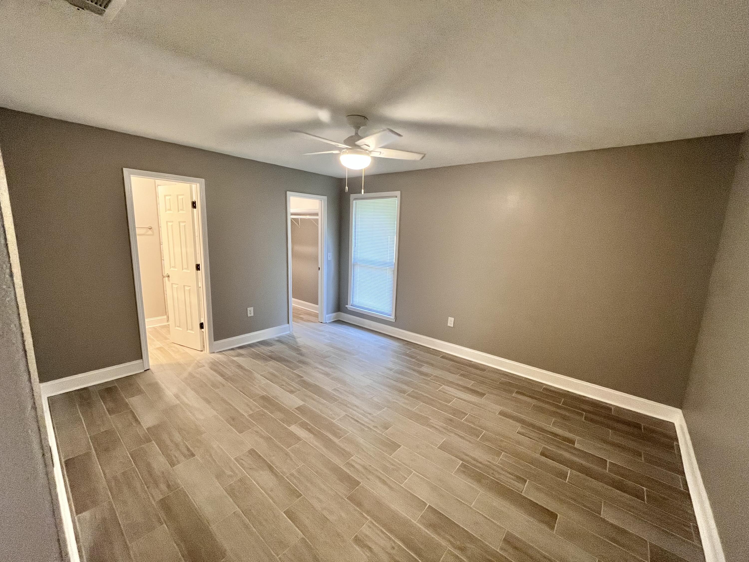795 Bay Street Crestview, FL 32536 - Photo 9 of 16 wooden floor in an empty room with a window