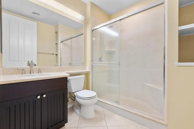 a bathroom with a sink mirror toilet and shower