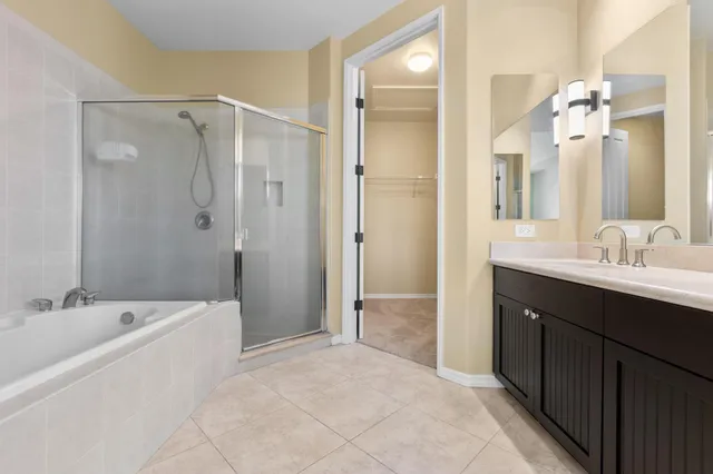 a bathroom with a tub sink shower and mirror