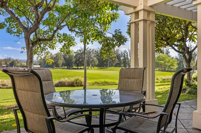 a view of a balcony with a table and chairs