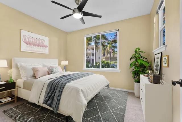 a bedroom with a large bed and a potted plant