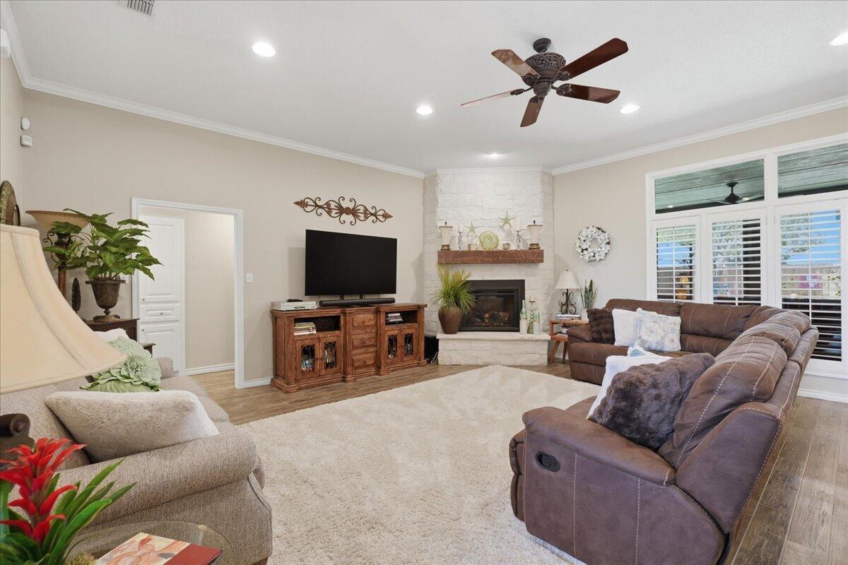 4612 100th Street Lubbock, TX 79424 - Photo 8 of 55 a living room with furniture a flat screen tv and a large window