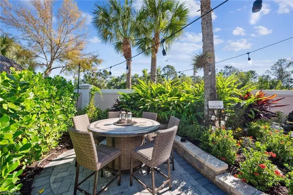 a view of a backyard with furniture and a garden