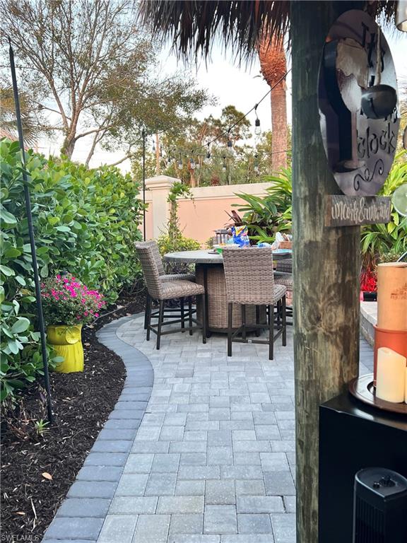 13575 Snook Circle Naples, FL 34114 - Photo 23 of 50 a view of a patio with a table and chairs