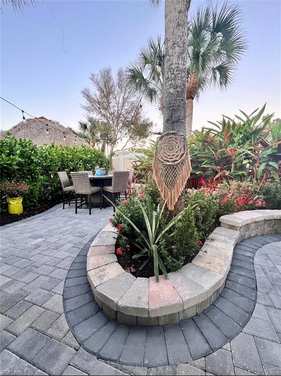 13575 Snook Circle Naples, FL 34114 - Photo 25 of 50 a view of a swimming pool with sitting area