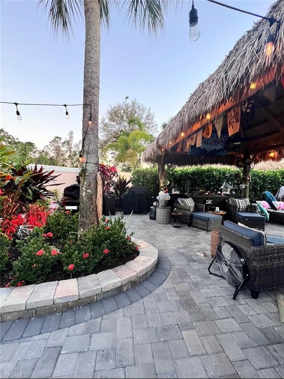 13575 Snook Circle Naples, FL 34114 - Photo 27 of 50 a view of a patio with table and chairs potted plants