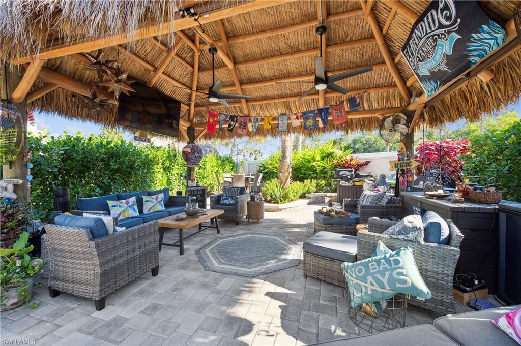 13575 Snook Circle Naples, FL 34114 - Photo 42 of 50 a living room with patio furniture and a potted plants