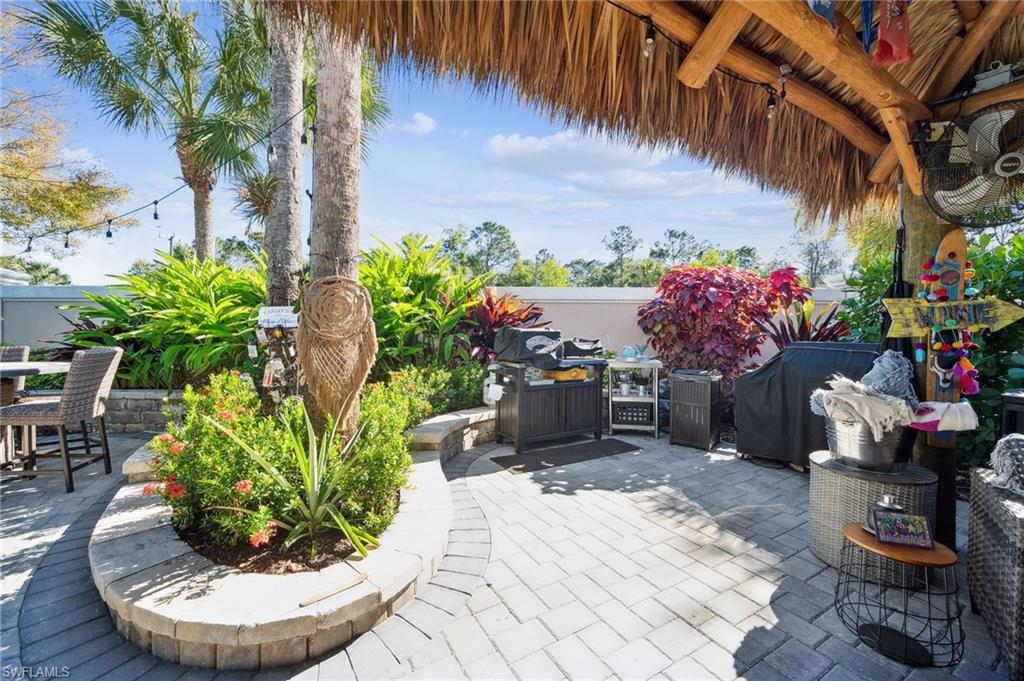 13575 Snook Circle Naples, FL 34114 - Photo 7 of 50 a view of a entryway with flower pots