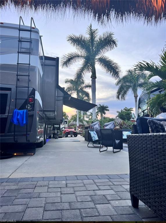 13575 Snook Circle Naples, FL 34114 - Photo 9 of 50 a view of outdoor space with swimming pool and sitting area