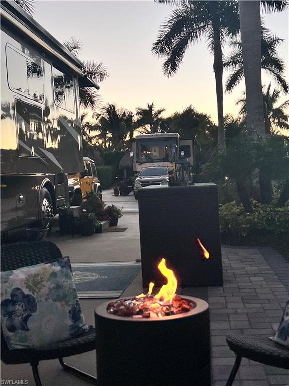 13575 Snook Circle Naples, FL 34114 - Photo 10 of 50 a view of a patio with table and chairs and a fire pit