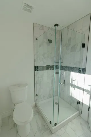 a bathroom with a shower and toilet