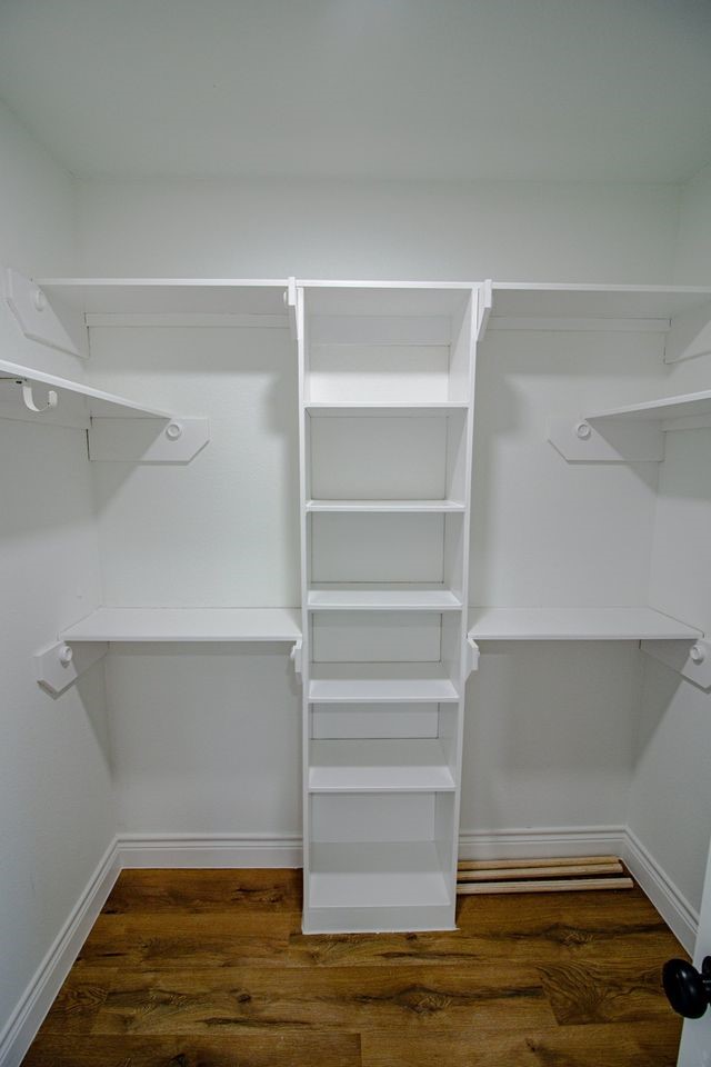 1407 Odd Fellow Street, Unit A Conroe, TX 77301 - Photo 13 of 16 a view of walk in closet with empty racks