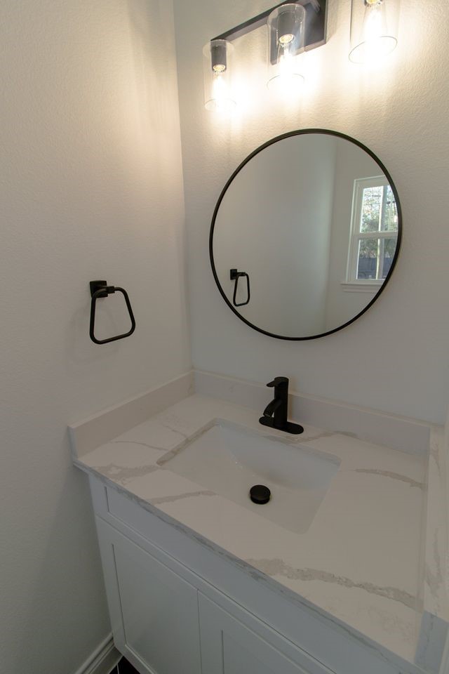 1407 Odd Fellow Street, Unit A Conroe, TX 77301 - Photo 15 of 16 a bathroom with a sink and a mirror