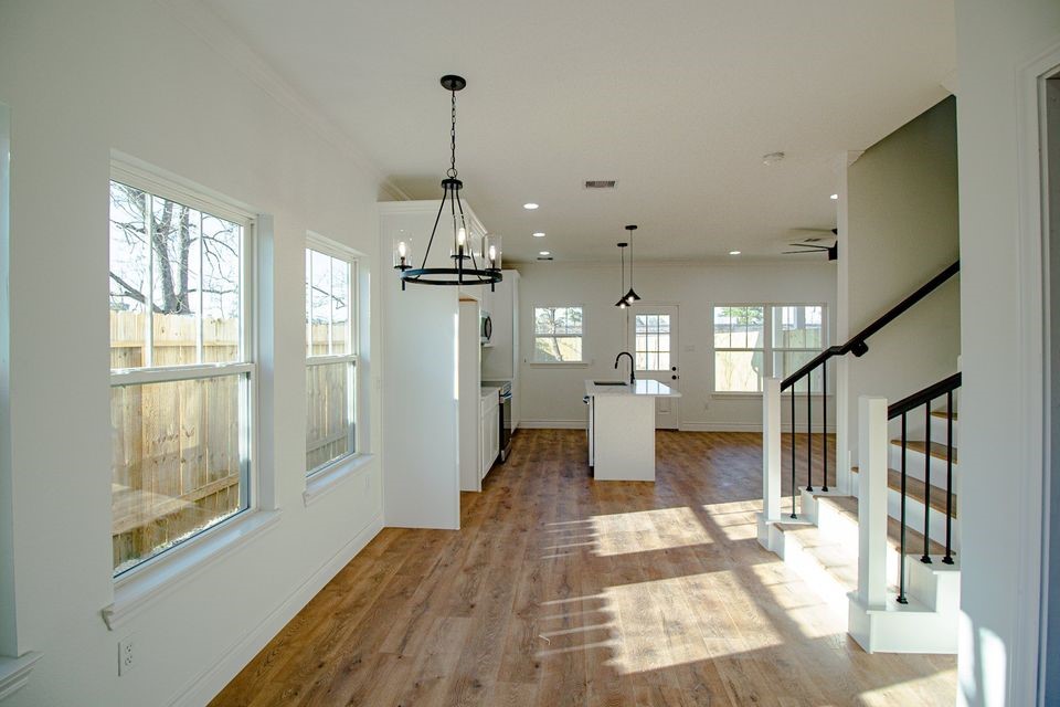 1407 Odd Fellow Street, Unit A Conroe, TX 77301 - Photo 2 of 16 a view of empty room with wooden floor and windows