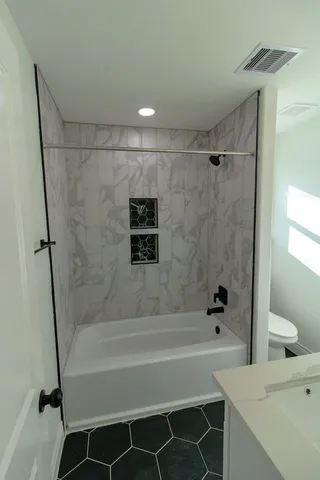 a bathroom with a bathtub and a shower