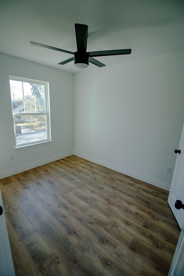 1407 Odd Fellow Street, Unit A Conroe, TX 77301 - Photo 10 of 16 a view of an empty room with a window