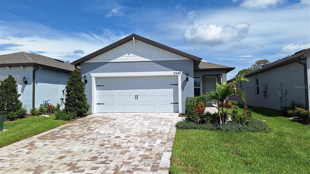 9449 Ballaster Pointe Loop Palmetto, FL 34221 - Photo 1 of 1 a front view of a house with a yard and garage