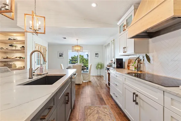 a kitchen with sink a stove and cabinets