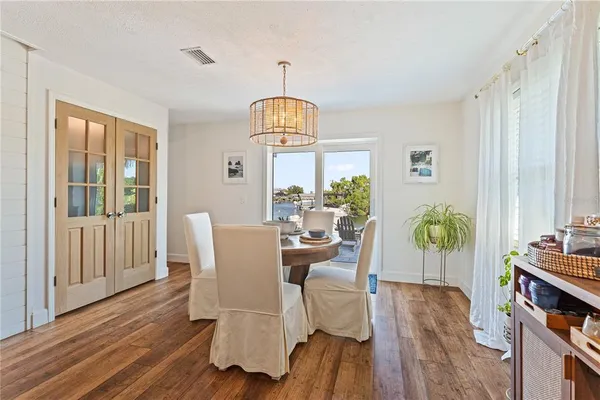 a view of a dining room with furniture window and wooden floor