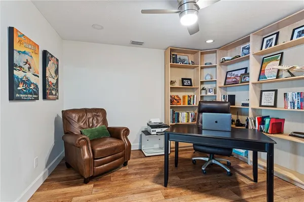 a work room with furniture and a book shelf