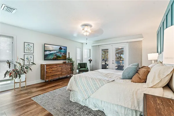 a bedroom with a bed and a flat screen tv