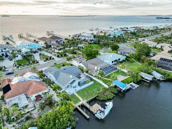 an aerial view of a house with a garden and lake view