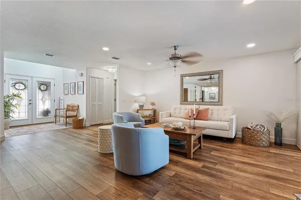 a living room with furniture and a wooden floor