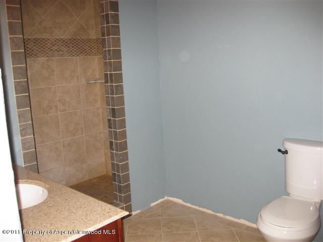 322 East 1st Street Rifle, CO 81650 - Photo 8 of 8 a bathroom with a toilet and a shower