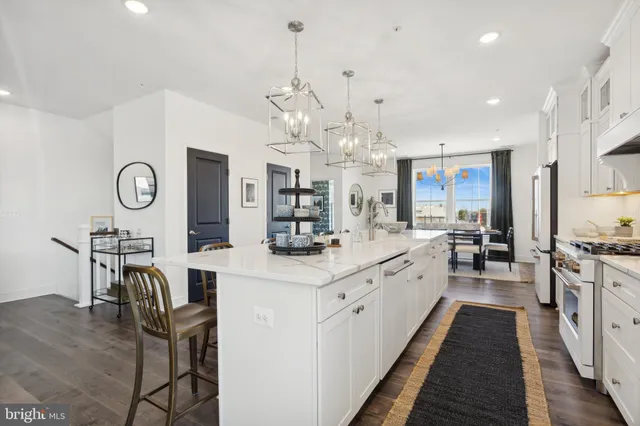 a large kitchen with stainless steel appliances kitchen island granite countertop a sink and cabinets